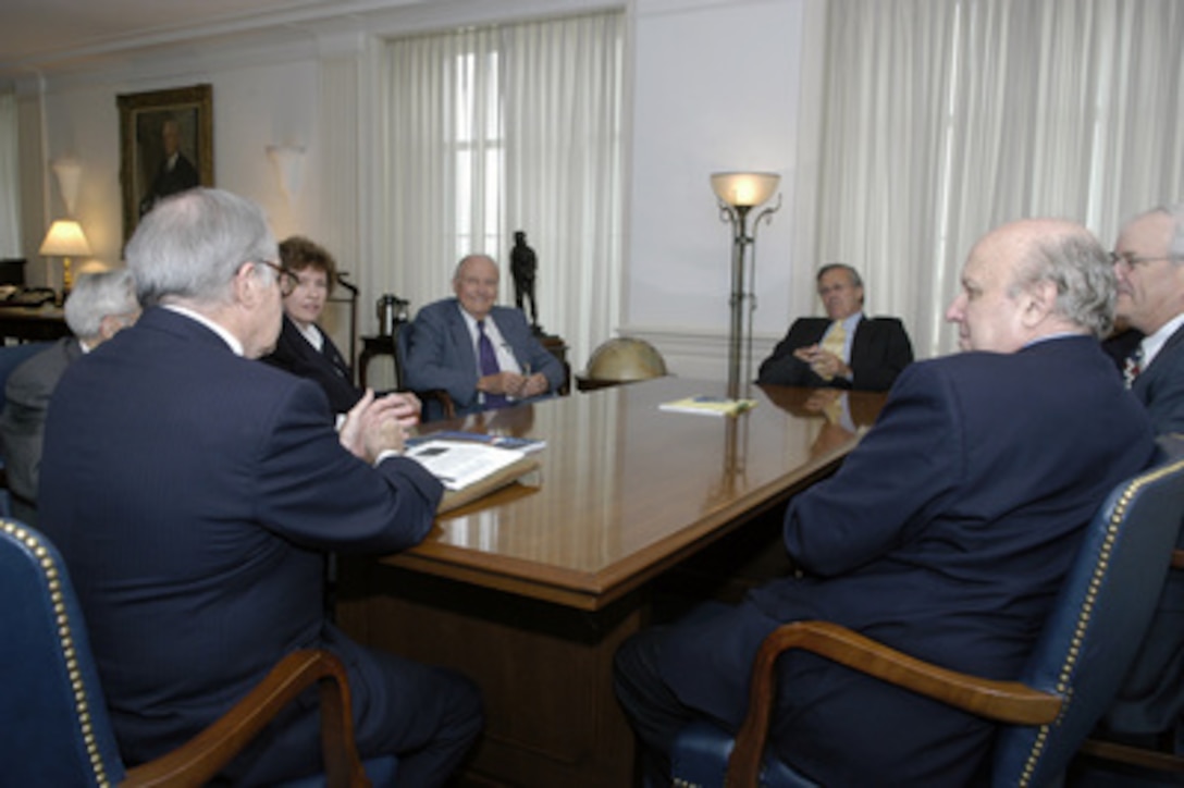 Technology and Privacy Advisory Committee (TAPAC) Chairman Newton Minow (left) presents the committee's final report to Secretary of Defense Donald H. Rumsfeld (3rd from right) on May 27, 2004. The committee was charged with advising the secretary on the protection of personal privacy during the pursuit of technological solutions to identify terrorists and prevent terrorist attacks against the United States. Members are from left to right: Minow, Lisa Davis, John O. Marsh Jr., Rumsfeld and Floyd Abrams. 