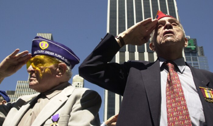 World War II veterans stand and salute their beloved national colors during the opening of the Bryant Park World War II Memorial Dedication ceremony Saturday. The official ceremony was actually held in Washington D.C., at the newly unvieled monument, but was televised through a live satalite feed so New Yorkers could witness the historic event.