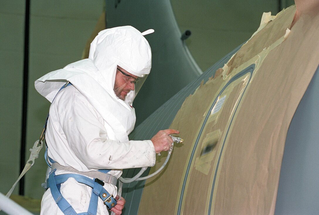 TINKER AIR FORCE BASE, Okla. -- Kenneth Kilgore paints stenciling on a KC-135 Stratotanker emergency exit door.  (U.S. Air Force photo by Margo Wright)
