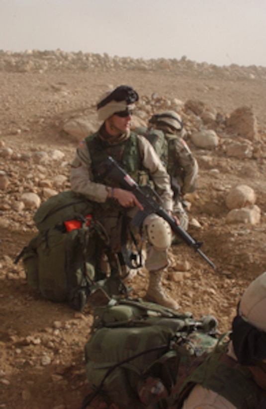 A U.S. Army soldier watches for signs of anti-coalition forces while providing security at a landing zone in Daychopan District, Zabol Province, Afghanistan, on Oct. 23, 2004. This operation is being conducted by Alpha Company, 2nd Battalion, 35th Infantry Regiment, 25th Infantry Division. 