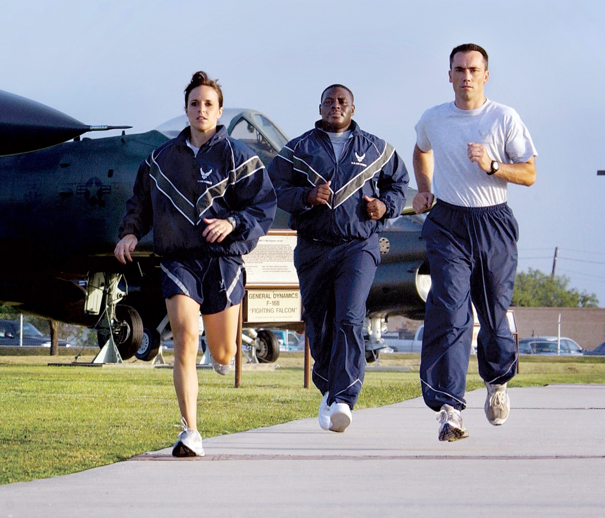 LACKLAND AIR FORCE BASE, Texas -- First Lt. Megan Schafer (from left), Staff Sgt. Antwain Wright and Master Sgt. Scott Wagers show off different combinations of the new physical training uniform while jogging here during the wear-test phase.  The new uniform will be issued to Airmen serving in Southwest Asia first and phased into the rest of the force over the next three years.  (U.S. Air Force photo by Master Sgt. Efrain Gonzalez)