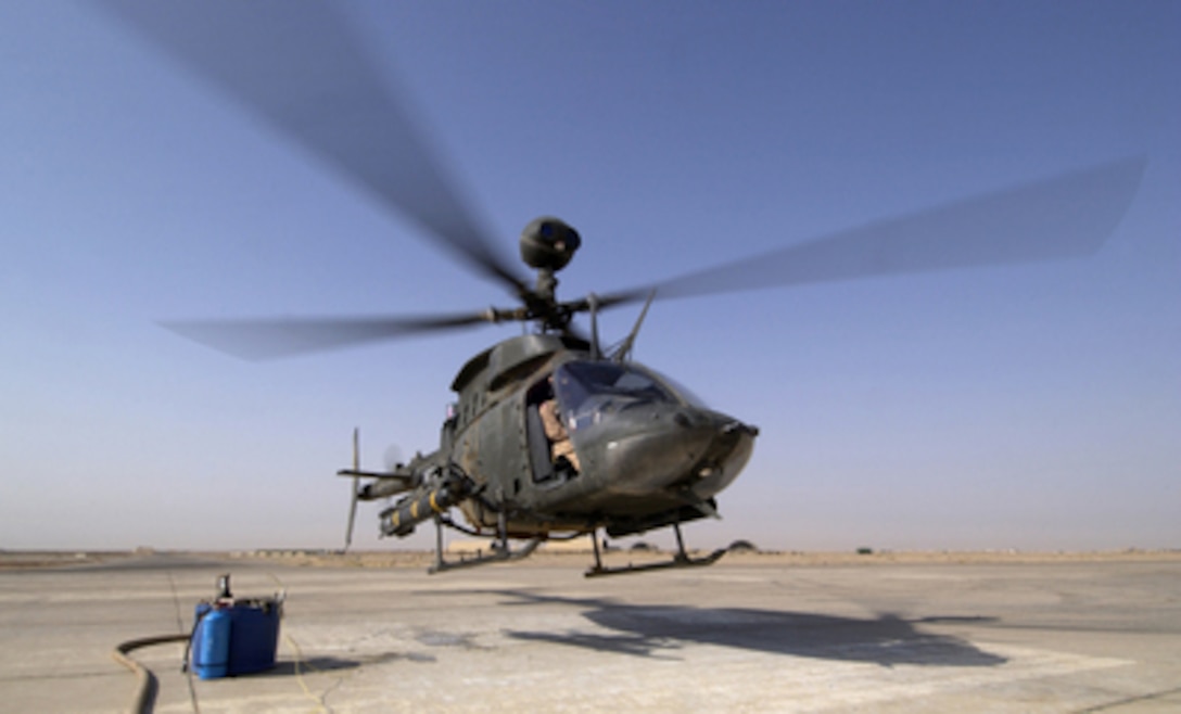 An OH-58D Kiowa Warrior helicopter takes off from Forward Operating Base MacKenzie in Iraq after being armed and refueled on Oct. 28, 2004. The Kiowa is assigned to Delta Troop, 1st Battalion, 4th Cavalry Regiment, 1st Infantry Division. 