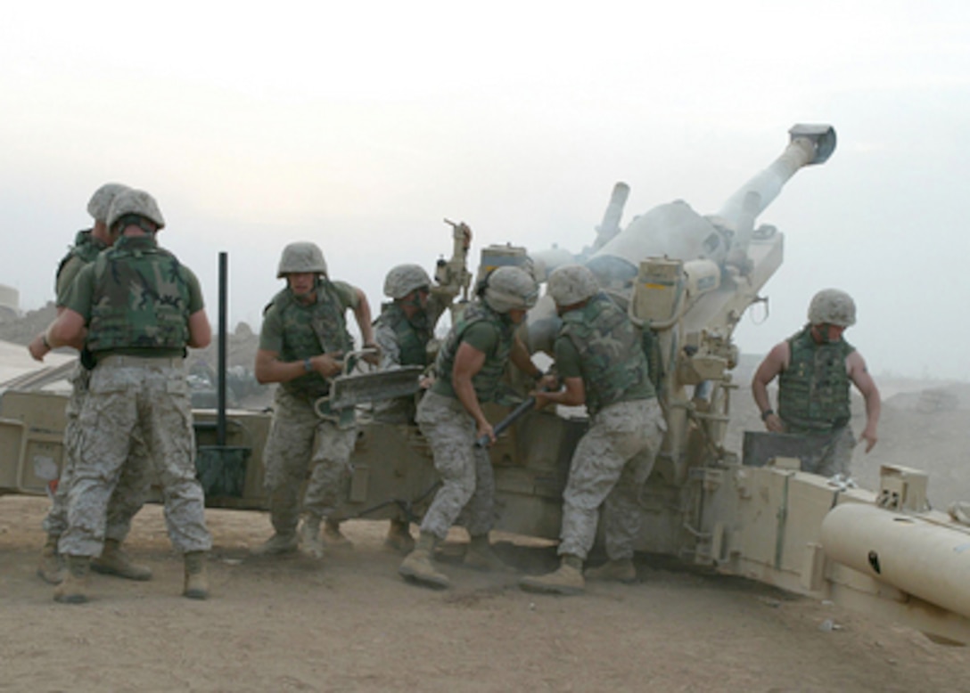 U.S. Marines fire an M198 Medium Howitzer providing supporting and defensive fire for Camp Fallujah in Iraq on Oct. 21, 2004. The Marines are assigned to M Battery, 4th Battalion, 14th Infantry Regiment, 1st Marine Division RCT-1. 