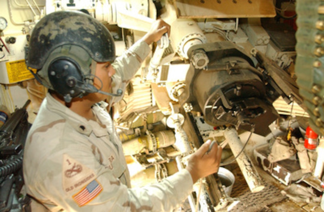 Army Spc. Frank Guerra prepares to fire rounds from a M109A6 Paladin artillery vehicle as part of a counter fire mission against insurgents near the town of Falluja, Iraq, on Nov. 5, 2004. Guerra is assigned to Alpha 382nd, 2nd Brigade Combat Team, 1st Cavalry. 