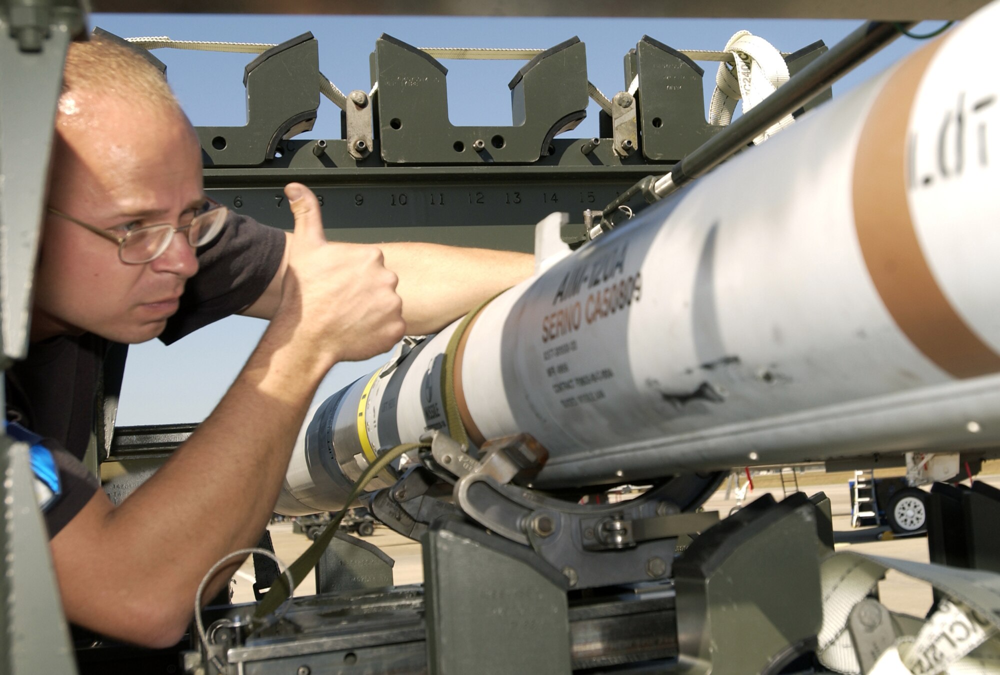 TYNDALL AIR FORCE BASE, Fla. -- Staff Sgt. Kevin Skaggs prepares to load a missile during William Tell 2004 here Nov. 8.  This is the 50th anniversary of the competition, which tests an aircrew's ability to perform under combat conditions.  Two weeks of competition will challenge pilots, weapons loaders and maintainers from five F-15 Eagle fighter squadrons.  Sergeant Skaggs is assigned to the 95th Air Maintenance Unit here.  (U.S. Air Force photo by Staff Sgt. Tanika Bell)