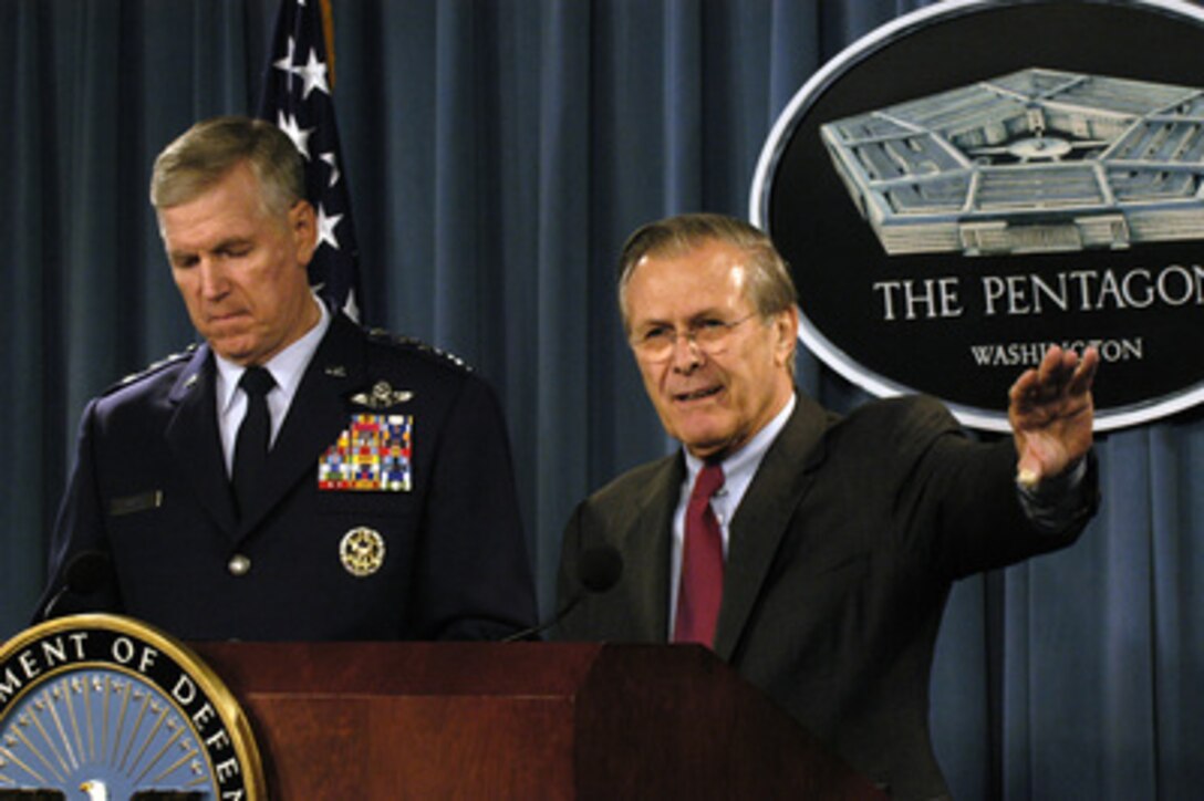 Secretary of Defense Donald H. Rumsfeld (right) responds to a reporter's question during a Pentagon press briefing on Nov. 8, 2004. Rumsfeld and Chairman of the Joint Chiefs of Staff Gen. Richard B. Myers, USAF, provided an update on the course of the war in Iraq. 