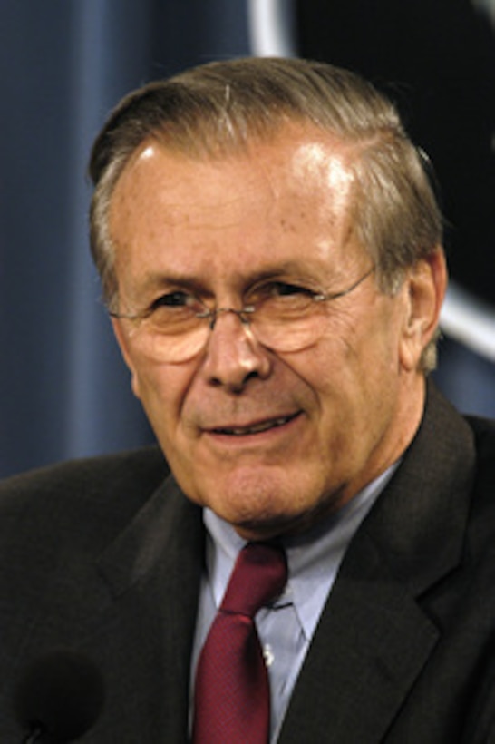 Secretary of Defense Donald H. Rumsfeld listens to a reporter's question.