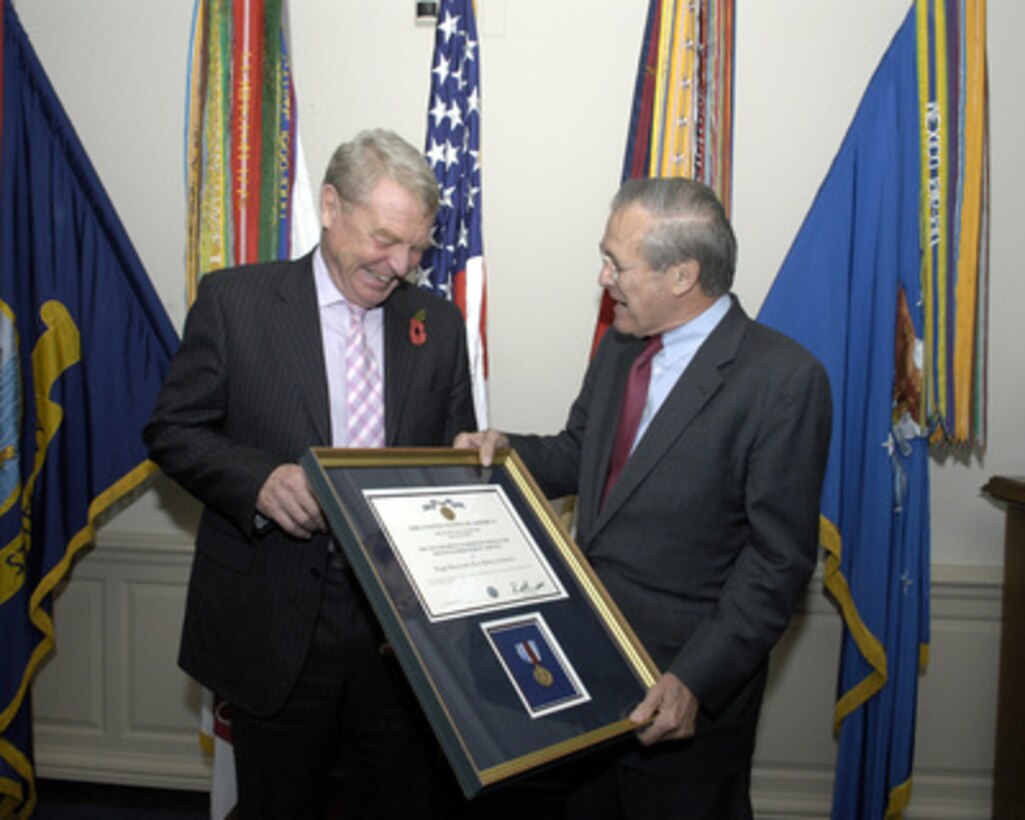 Secretary of Defense Donald H. Rumsfeld (right) presents the Department of Defense Distinguished Public Service Award to Lord Paddy Ashdown for service as High Representative for Bosnia and Herzegovina. Rumsfeld presented the award in the Pentagon following their meeting on Nov. 8, 2004. 