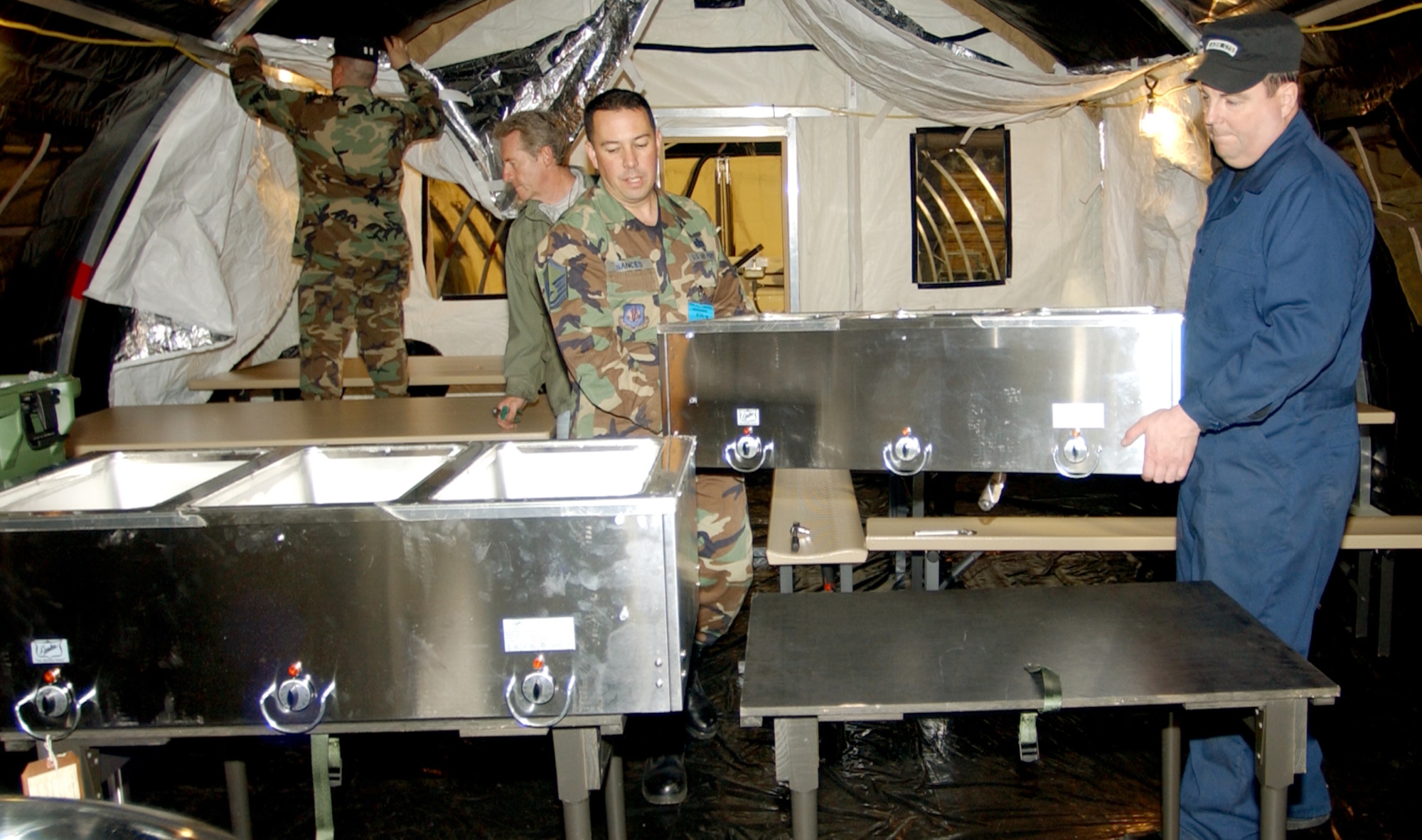 SANEM, Luxembourg -- Workers assemble a portion of the "550 I" Basic Expeditionary Airfield Resources base kit here.  The tent city kit, the first of its kind in the Air Force, includes lodging, dining, shower and latrine units that can accommodate 550 people.  (U.S. Air Force photo by Senior Airman Desiree N. Palacios)