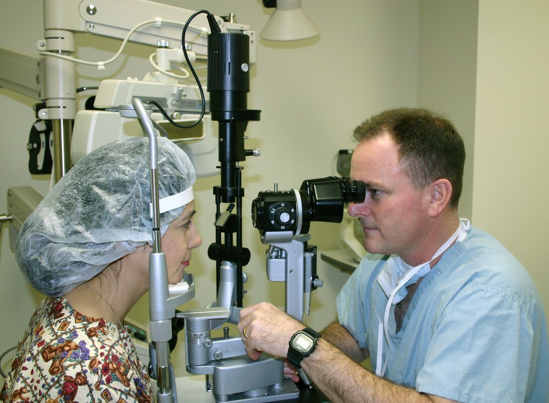 LACKLAND AIR FORCE BASE, Texas -- Col. (Dr.) Robert Smith examines a postoperative LASIK eye surgery patient at Wilford Hall Medical Center here.  Certain aviators can now undergo a new laser eye surgery procedure.  Dr. Smith is chief of cornea and refractive surgery at the medical center.  (U.S. Air Force photo by Sue Campbell)
