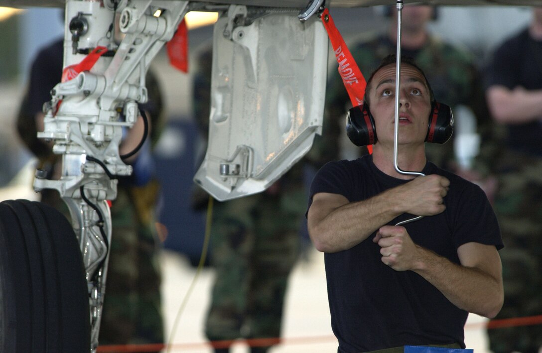 TYNDALL AIR FORCE BASE, Fla. -- Senior Airman Josh P. Pousson, prepares an F-15 Eagle for the live ammunition load competition during William Tell 2004 here Nov. 10.  William Tell, which tests an aircrew's ability to perform under combat conditions, is a two week competition which challenges pilots, weapons loaders and maintainers from five F-15 fighter wings.  Airman Pousson is assigned to the Oregon National Guard's 142nd Aircraft Maintenance Squadron.  (U.S. Air Force photo by Master Sgt. Robert W. Valenca)