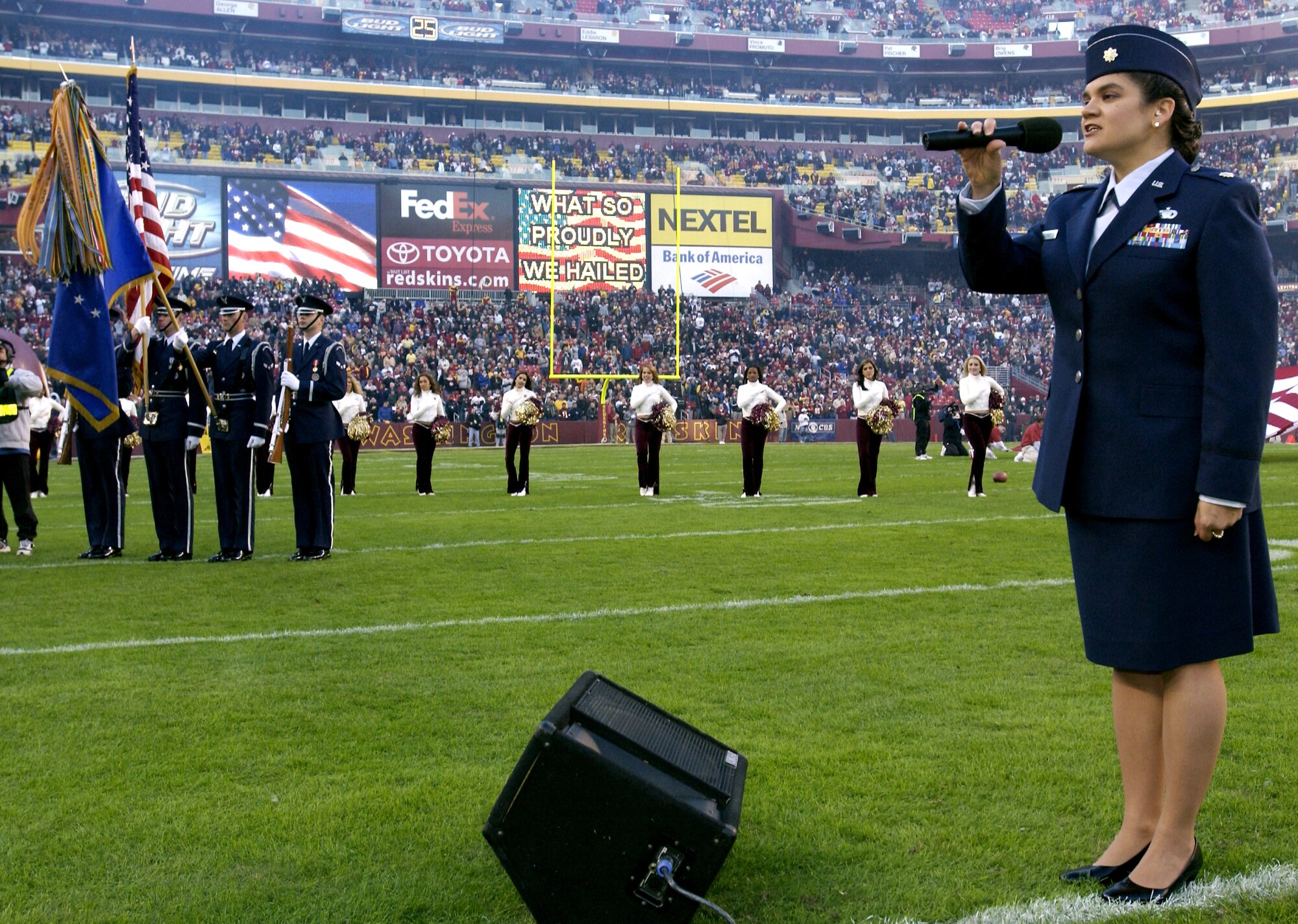 LANDOVER, Md. -- Maj. Katherine Strus sings the national anthem during opening ceremonies at the Washington Redskins vs. Cincinnati Bengals football game here Nov. 14.  It was part of a Veterans Day salute to the Air Force.  Major Strus is assigned to the Air Force's legislative liaison office at the Pentagon.  Also part pf the tribute, a U.S. Air Force Honor Guard team posted the colors.  (U.S. Air Force photo by Master Sgt. Jim Varhegyi) 



