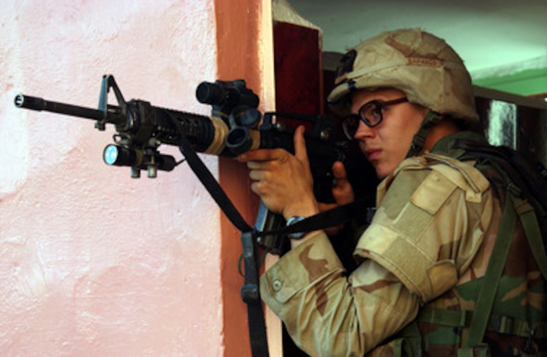 A U.S. Army soldier watches for insurgents in Fallujah, Iraq, during Operation al Fajr (New Dawn) on Nov. 9, 2004. The soldier is assigned to 2nd Battalion, 5th Cavalry Regiment, 2nd Brigade Combat Team, 1st Cavalry Division. 