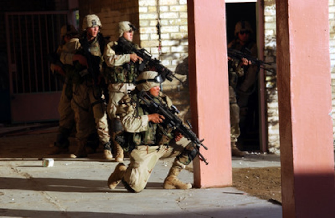 U.S. Army soldiers use a wall and a pillar as a shield while they tactically enter and clear a building in Fallujah, Iraq, during Operation al Fajr (New Dawn) on Nov. 9, 2004. The soldiers are assigned to 2nd Battalion, 5th Cavalry Regiment, 2nd Brigade Combat Team, 1st Cavalry Division. 