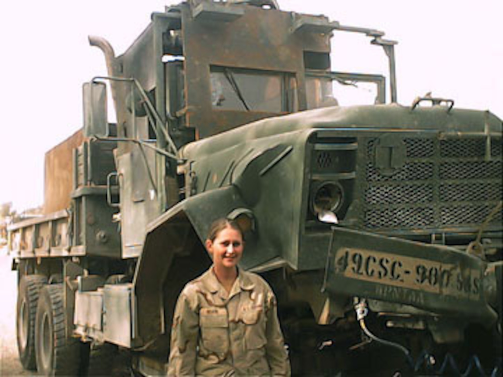 IRAQ -- Staff Sgt. Amelia Solomon stands in front of the truck she was commanding when the truck in front of hers was hit by an improvised explosive device here.  She earned a Purple Heart for the injuries she received during that convoy mission with the Army.  Sergeant Solomon is assigned to the 100th Logistics Readiness Squadron at Royal Air Force Mildenhall, England.  (U.S. Air Force photo by Staff Sgt. Jason Robinson)