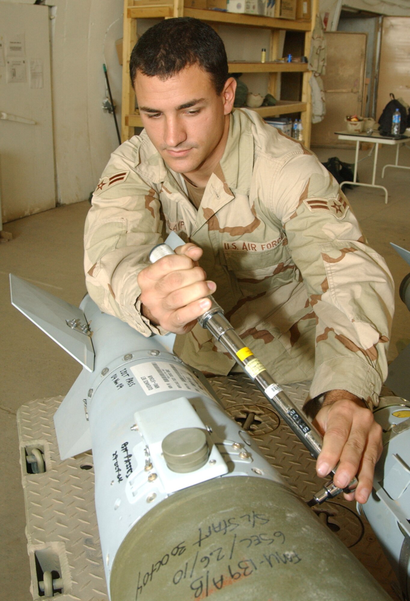 BALAD AIR BASE, Iraq -- Airman 1st Class Michael Claypoole assembles a GBU-38 500-pound Joint Direct Attack Munition.  The new munition is designed to reduce collateral damage, limit unintended casualties and take the fight up close and personal to enemy insurgents and anti-Iraqi forces alike.  Airman Claypoole is a munitions systems journeyman with the 332nd Expeditionary Maintenance Squadron here.  (U.S. Air Force photo by Master Sgt. David Reagan)