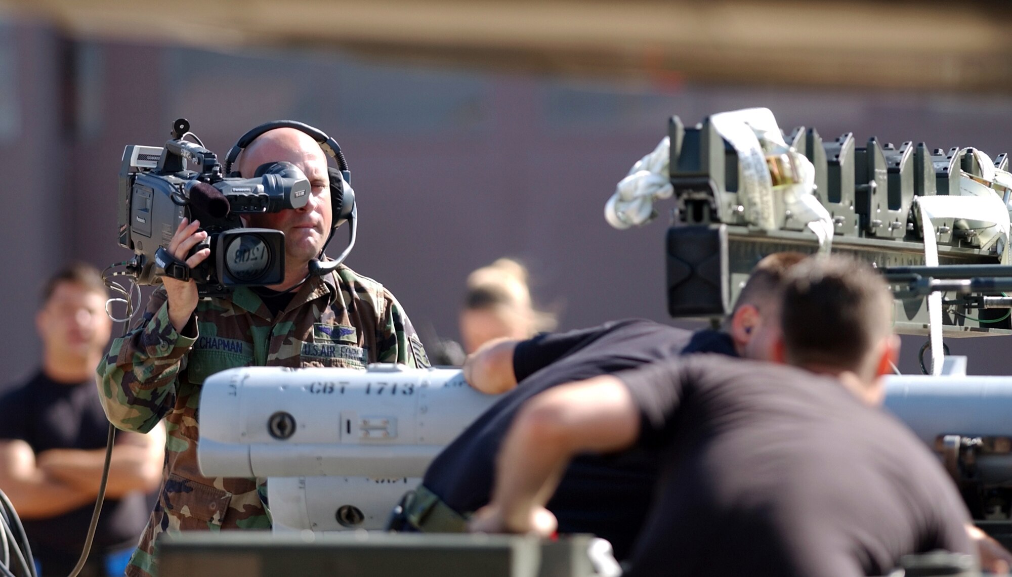 TYNDALL AIR FORCE BASE, Fla. (AFPN) -- Tech. Sgt. Jamie Chapman films the static load portion of William Tell 2004 here Nov. 9.  He is a member of the William Tell Visual Information Documentation team and assigned to the 30th Communications Squadron at Vandenberg Air Force Base, Calif.  (U.S. Air Force photo by Tech. Sgt. Lisa M. Zunzanyika)