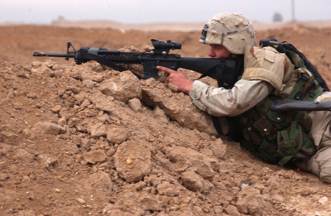 A U.S. Army soldier watches out for insurgents during Operation al Fajr (New Dawn) in Fallujah, Iraq, on Nov. 8, 2004. The soldier is assigned to 1st Platoon, Apache Troop, 2nd Battalion, 5th Cavalry Regiment, 2nd Brigade Combat Team, 1st Cavalry Division. 
