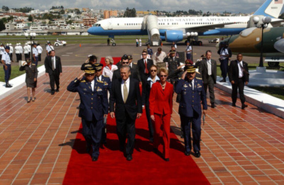Secretary of Defense Donald H. Rumsfeld is escorted by U.S. Ambassador to Ecuador Kristie Kenney and leaders of the Ecuadorian military as he arrives in Quito, Ecuador, on Nov. 14, 2004. Rumsfeld and 33 more defense ministers from throughout the Western Hemisphere are assembling in Quito to attend the Defense Ministerial of the Americas conference that will focus on strengthening the inter-American security system. 