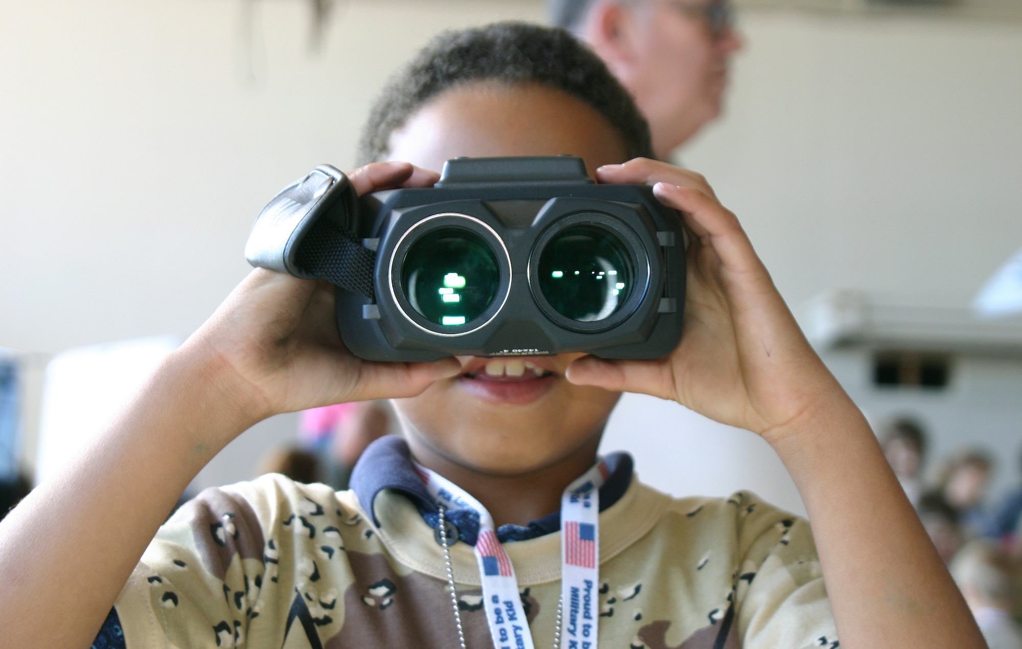 SHEPPARD AIR FORCE BASE, Texas -- Josiah Vandecruze looks through a pair of night-vision binoculars during Operation Kids Investigating Deployment Services.  The operation gave children an opportunity to see what their parents go through during a deployment.  (U.S. Air Force photo by Airman 1st Class Jacque Lickteig)