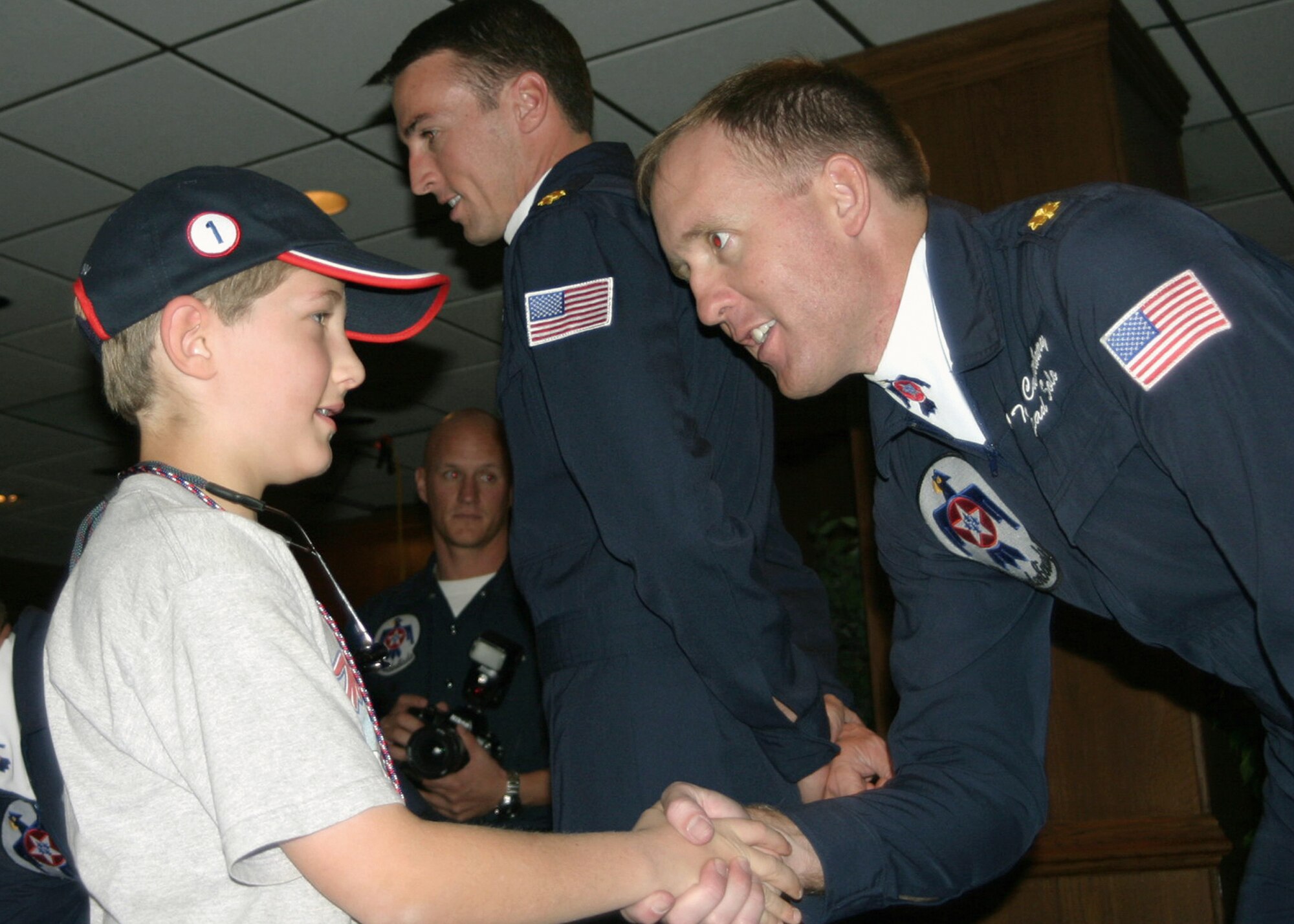 NELLIS AIR FORCE BASE, Nev. -- Buddy LaFontaine meets Maj. Todd Canterbury at the Thunderbird hangar during an air show.  Buddy's dream to meet the Thunderbird pilot came true through the Make-A-Wish Foundation.  Major Canterbury is the lead solo pilot for the Thunderbirds.  (U.S. Air Force photo by Julie Ray)