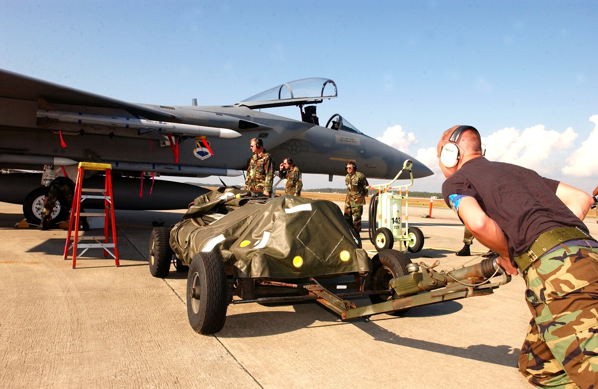 TYNDALL AIR FORCE BASE, Fla. -- Airmen from the 95th Fighter Squadron's aircraft maintenance unit participate in the flightline load during William Tell 2004 here.  This is the 50th anniversary of the William Tell competition, which tests an aircrew's ability to perform under combat conditions.  (U.S. Air Force photo by Tech. Sgt Lisa M. Zunzanyika)