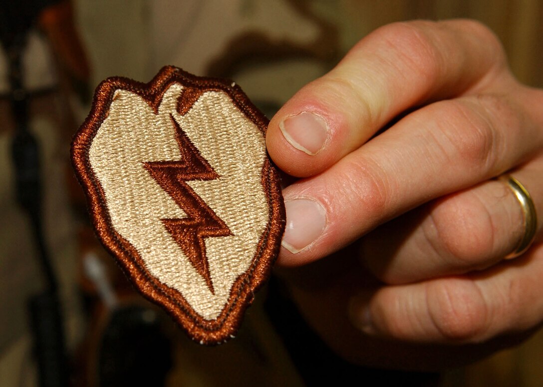 BAGRAM AIR BASE, Afghanistan -- An Airman shows off his newly acquired wartime service patch.  Army leaders award the shoulder-sleeve insignia to troops assigned to Army units serving in combat zones including 11 Airmen here.  (U.S. Air Force photo by Staff Sgt. Jennifer Lindsey)