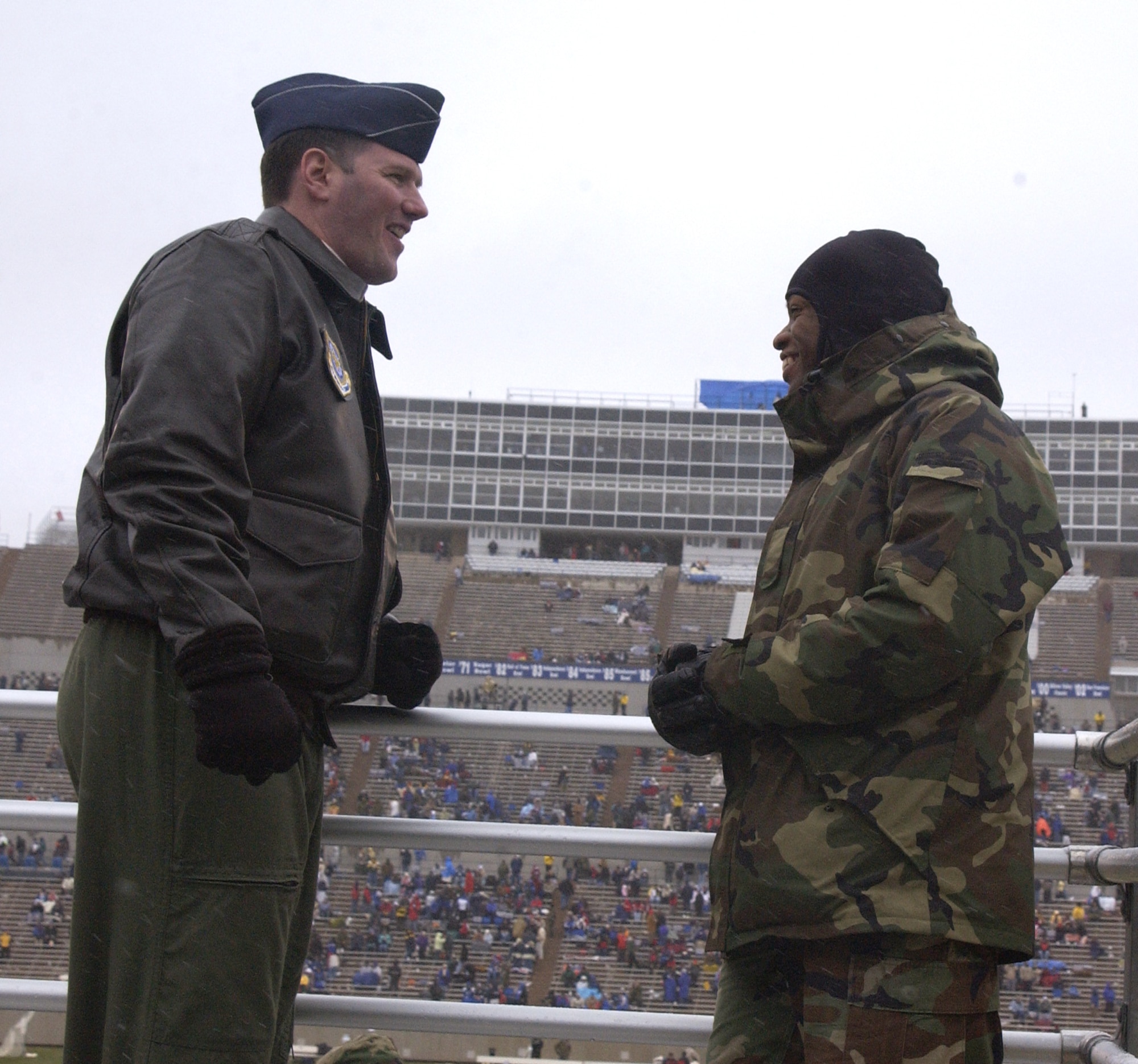 U.S. AIR FORCE ACADEMY -- Lt. Col. Joseph Hunt (left) and Cadet 2nd Class Xzavior Hill attend a football game here Nov.13.  Colonel Hill is the inspector general for the 92nd Air Refueling Wing at Fairchild Air Force Base, Wash.  Cadet Hill was paired with Colonel Hunt in the Big Brothers-Big Sisters program when he was a child.  (U.S. Air Force photo by Airman 1st Class Nathan Putz)