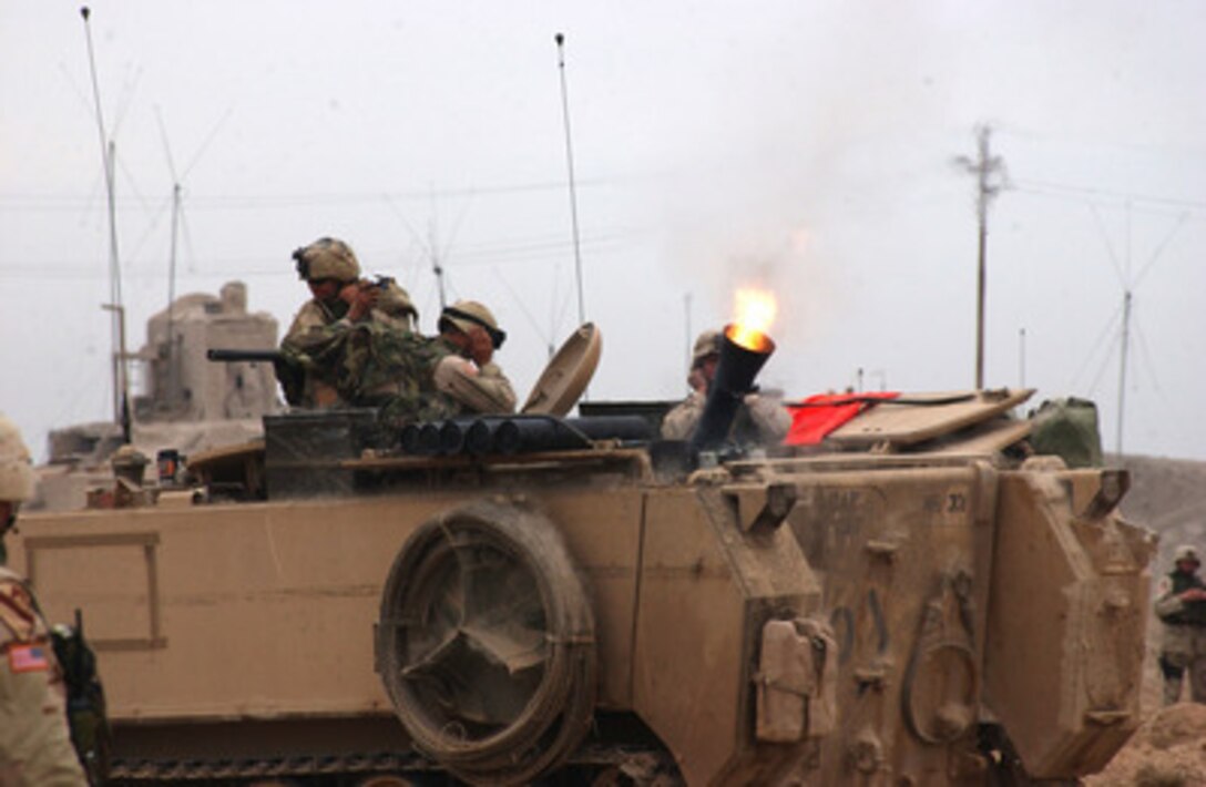 U.S. Army soldiers fire a mortar at insurgent positions in Fallujah, Iraq, during Operation al Fajr (New Dawn) on Nov. 8, 2004. The soldiers are assigned to Headquarters Company, 2nd Battalion, 5th Cavalry Regiment, 2nd Brigade Combat Team, 1st Cavalry Division. 