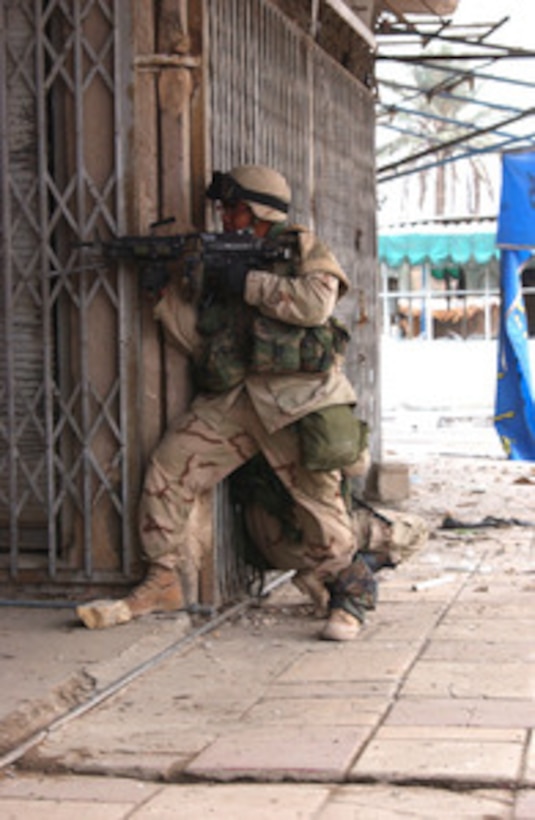 Two U.S. Army soldiers take position to cover fellow soldiers as they tactically enter and clear buildings in Fallujah, Iraq, during Operation al Fajr (New Dawn) on Nov. 9, 2004. The soldiers are assigned to 2nd Battalion, 5th Cavalry Regiment, 2nd Brigade Combat Team, 1st Cavalry Division. 