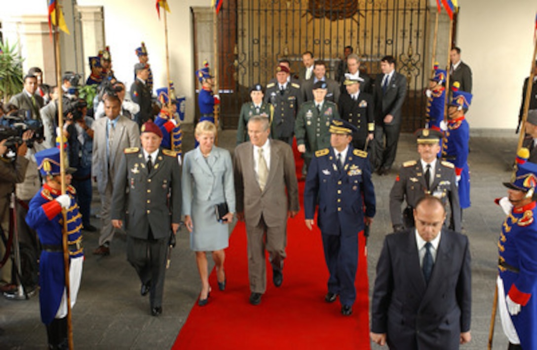 Leaders of the Ecuadorian military escort Secretary of Defense Donald H. Rumsfeld and U.S. Ambassador to Ecuador Kristie Kenney as they arrive at the Presidential Palace in Quito, Ecuador, on Nov. 14, 2004. Rumsfeld and 33 more defense ministers from throughout the Western Hemisphere are assembling in Quito to attend the Defense Ministerial of the Americas conference that will focus on strengthening the inter-American security system. 