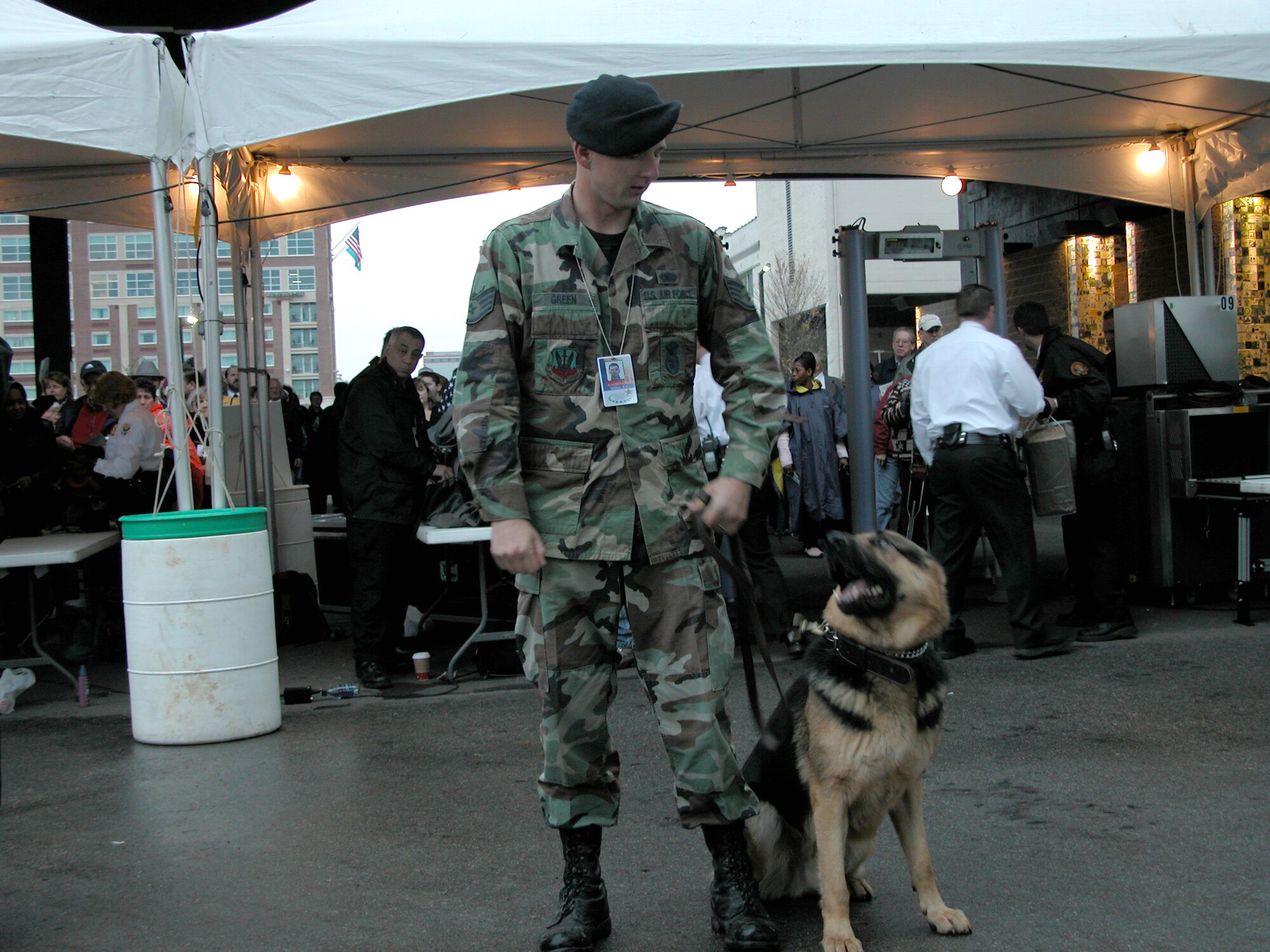 LITTLE ROCK, Ark. -- Staff Sgt. Gayden Green, a Barksdale Air Force Base, La., security forces journeyman, keeps his partner, Dax, in line as people file in for the William J. Clinton Presidential Library grand opening here Nov. 18.  An estimated 30,000 people, including current President George W. Bush and former Presidents Jimmy Carter, George H.W. Bush and Bill Clinton attended the opening ceremonies.  (U.S. Air Force photo by Tech. Sgt. Bob Oldham)
