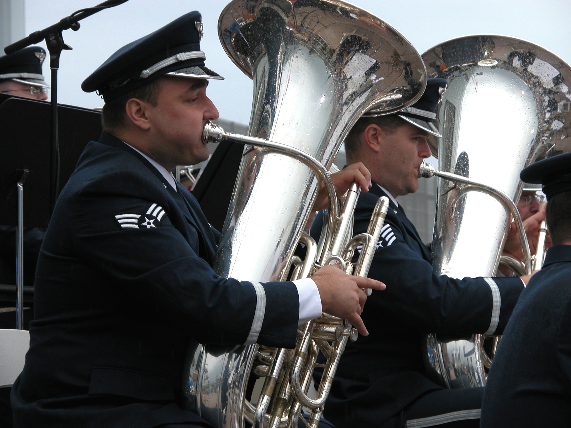 LITTLE ROCK, Ark. -- Tuba players Senior Airman Matt Kuebler (left) and Staff Sgt. David Hartung belt out a song at the William J. Clinton Presidential Library grand opening here Nov. 18.  They are assigned to the U.S. Air Force Band of Mid-America at Scott Air Force Base, Ill.  (U.S. Air Force photo by Tech. Sgt. Bob Oldham)
