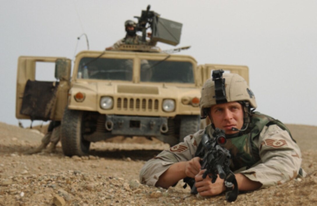 Air Force Staff Sgt. David Howe scans a field for suspicious enemy activity on Nov. 10, 2004. Howe is assigned to the 823rd Security Forces Squadron, Moody Air Force Base, Ga., and deployed with the 506th Expeditionary Security Forces Squadron to Kirkuk Air Base, Iraq. Expedition security forces personnel are responsible for securing specific off base sectors. 