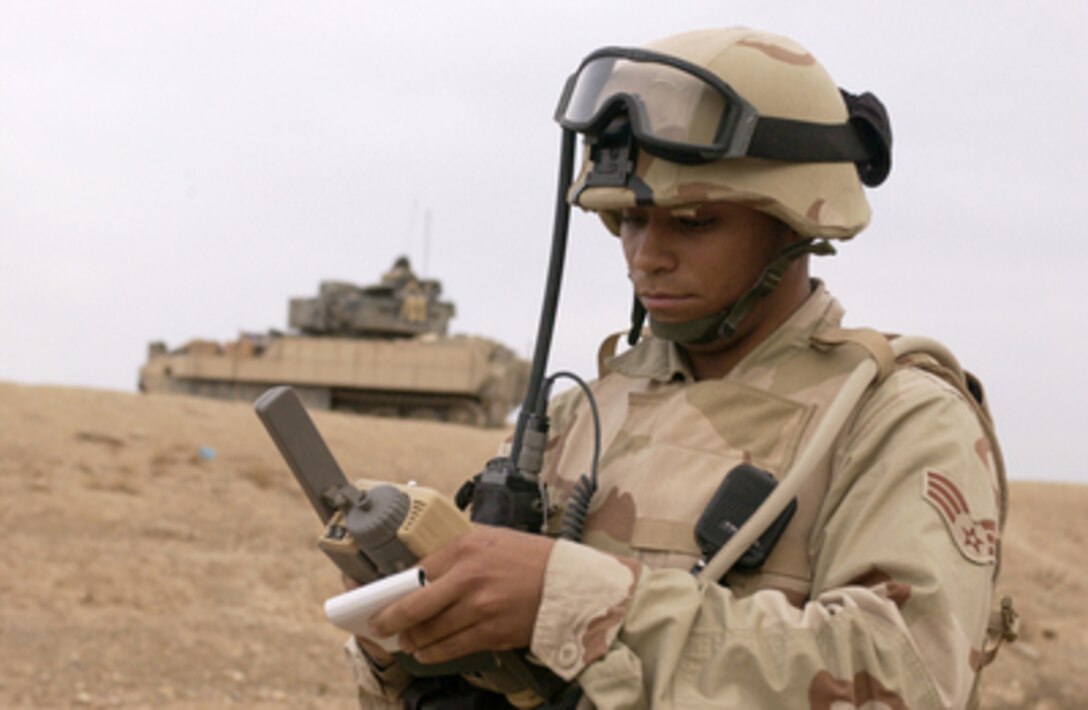 Air Force Senior Airman Ricky Williams acquires Global Positioning Systems coordinates for an air strike mission in Ad Dwr, Iraq, on Nov. 10, 2004. Williams is a Tactical Air Control Party member from Detachment 1, 2nd Air Support Operations Squadron, attached to 1st Battalion, 4th Cavalry Regiment, 1st Infantry Division. 
