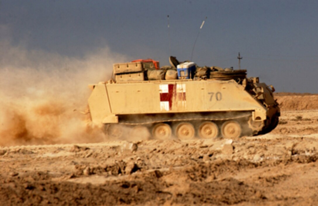 A medical track rushes wounded soldiers to medical attention during combat operations in Fallujah, Iraq, on Nov. 12, 2004. The armored personnel carrier is assigned to 7th Cavalry, 2nd Brigade Combat Team, 1st Cavalry Division. 