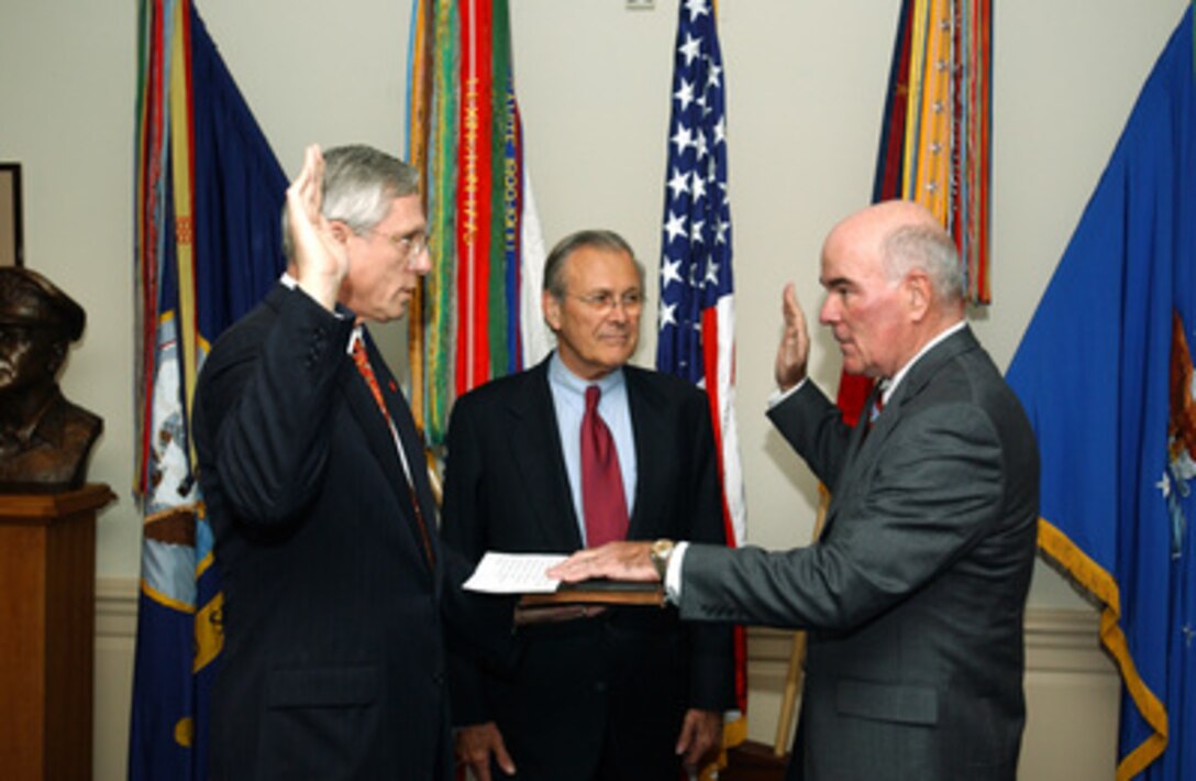 Francis J. Harvey (right) is administered the oath of office as the 19th Secretary of the Army by Raymond F. Dubois Jr. (left) while Secretary of Defense Donald H. Rumsfeld (center) watches during a Pentagon ceremony on Nov. 19, 2004. Dubois is the director of Administration and Management, Office of the Secretary of Defense. 