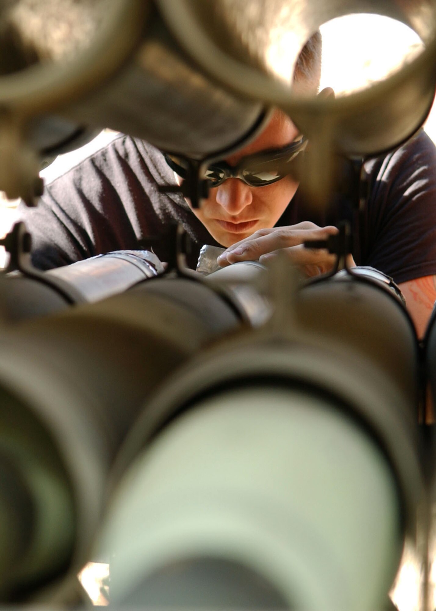 BAGRAM AIR BASE, Afghanistan -- Senior Airman Alton Bearden inspects rocket motor igniters for holes in the aluminum foil covering.  Sometimes they get punctured during handling.  The active-duty 455th Expeditionary Aircraft Maintenance Squadron Ammunitions Unit conventional maintenance crewmember is deployed to Afghanistan from Spangdahlem Air Base, Germany.  (U.S. Air Force photo by Staff Sgt. Jennifer Lindsey)