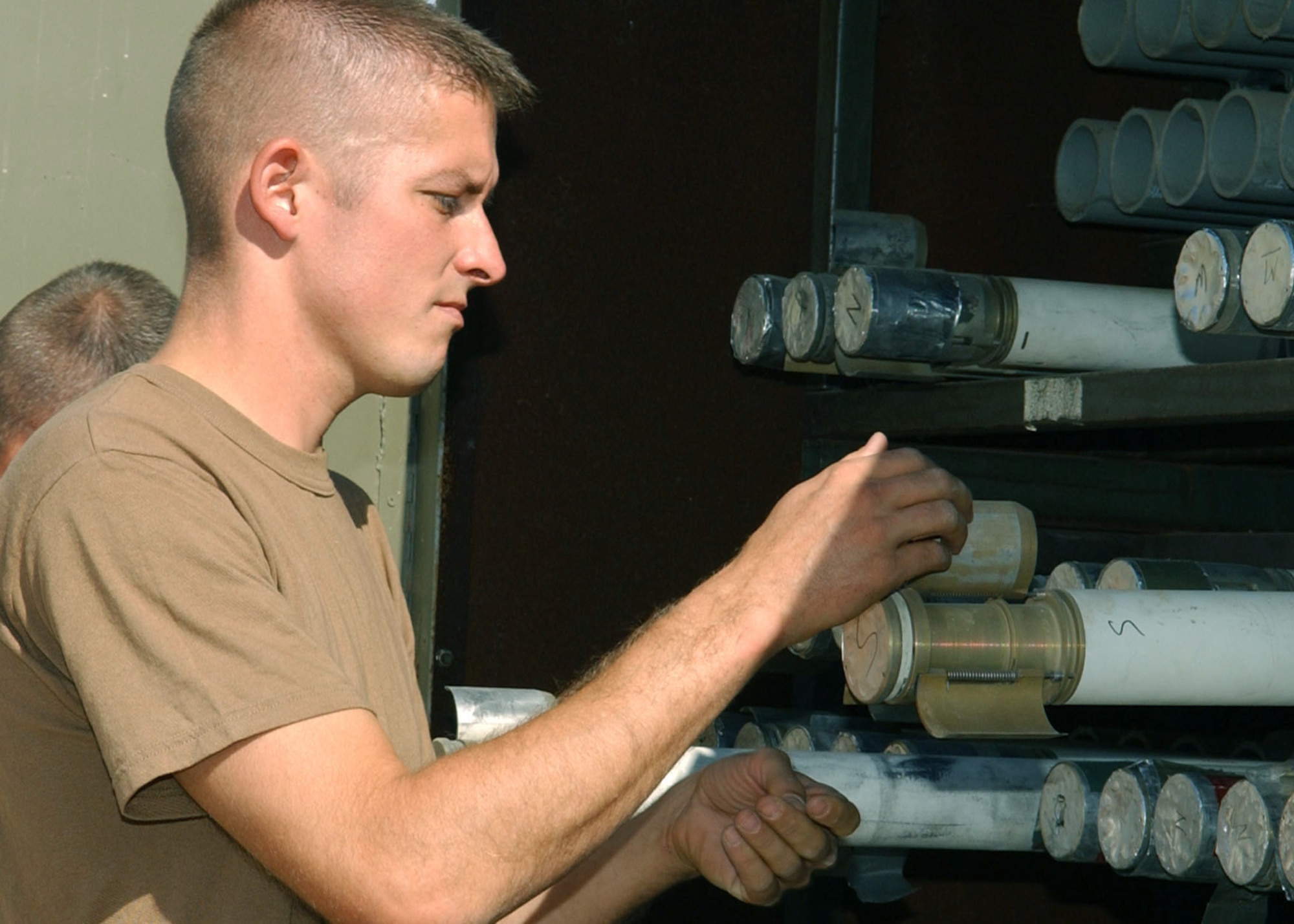 BAGRAM AIR BASE, Afghanistan -- Tech. Sgt. Daniel Hamilton inspects rocket fins to ensure they will open correctly when needed.  The conventional munitions crewmember is an Air Force reservist deployed to Afghanistan from Naval Air Station Joint Reserve Base New Orleans.  (U.S. Air Force photo by Staff Sgt. Jennifer Lindsey)