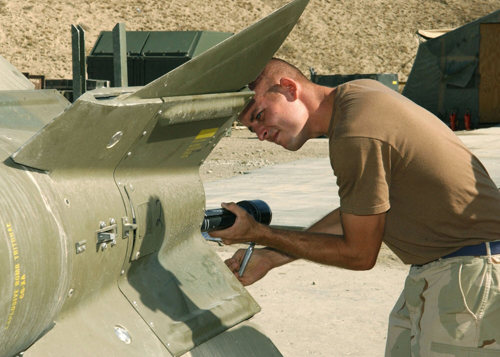BAGRAM AIR BASE, Afghanistan -- Tech. Sgt. Daniel Hamilton works at retracting the fins on a guided bomb.  Sergeant Hamilton is an Air Force reservist deployed to Afghanistan from Naval Air Station Joint Reserve Base New Orleans.  He is a conventional munitions crewmember assigned to the 455th Expeditionary Aircraft Maintenance Squadron ammunitions unit.  (U.S. Air Force photo by Staff Sgt. Jennifer Lindsey)
