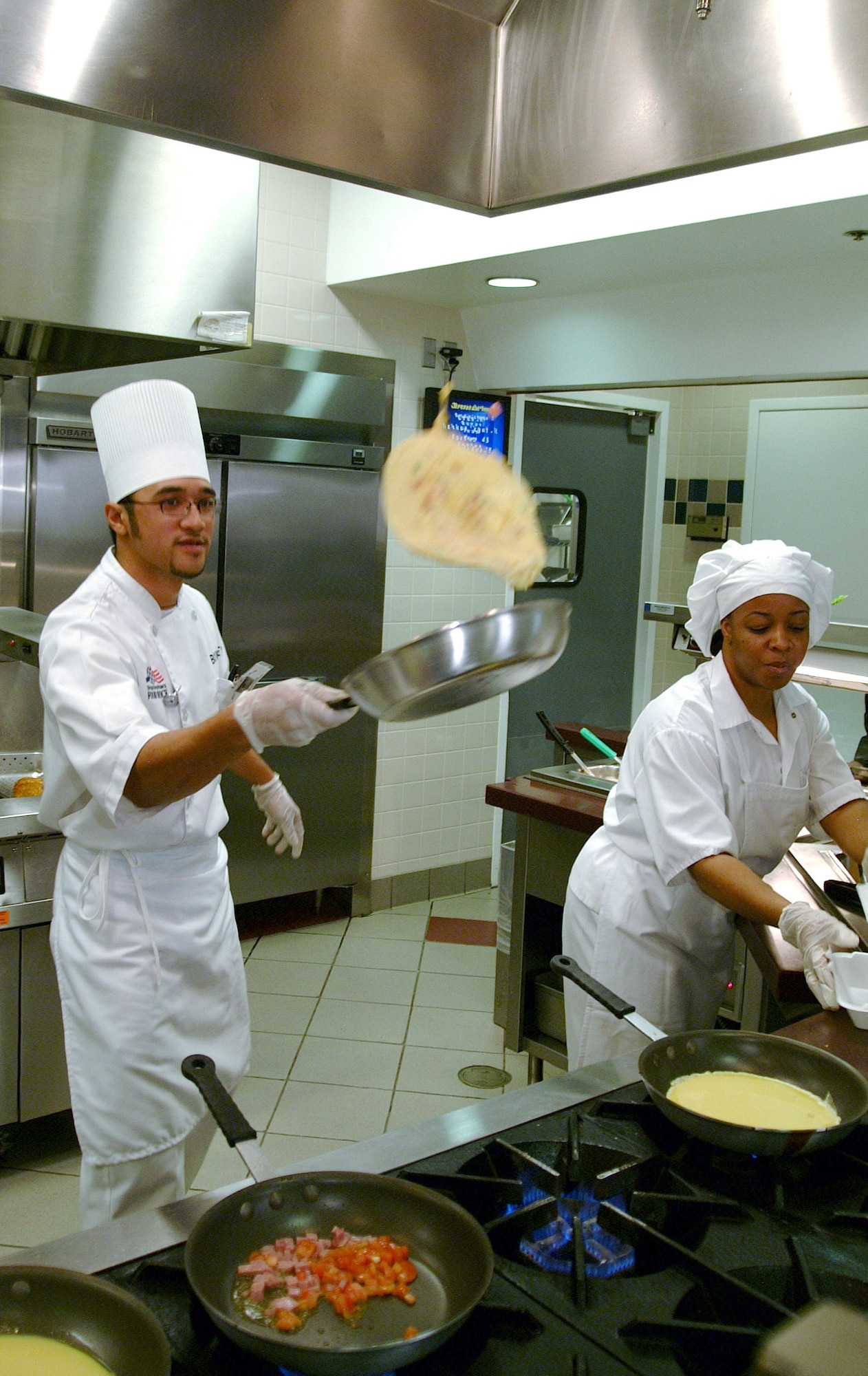 BUCKLEY AIR FORCE BASE, Colo. -- Francis Aragon flips an omelet as part of his entertaining cooking style.  He said his cooking style relies on talent, creativity and putting his heart into it.  Mr. Aragon is a food service worker at the dining facility here.  (U.S. Air Force photo by Airman 1st Class Christopher Smith)
