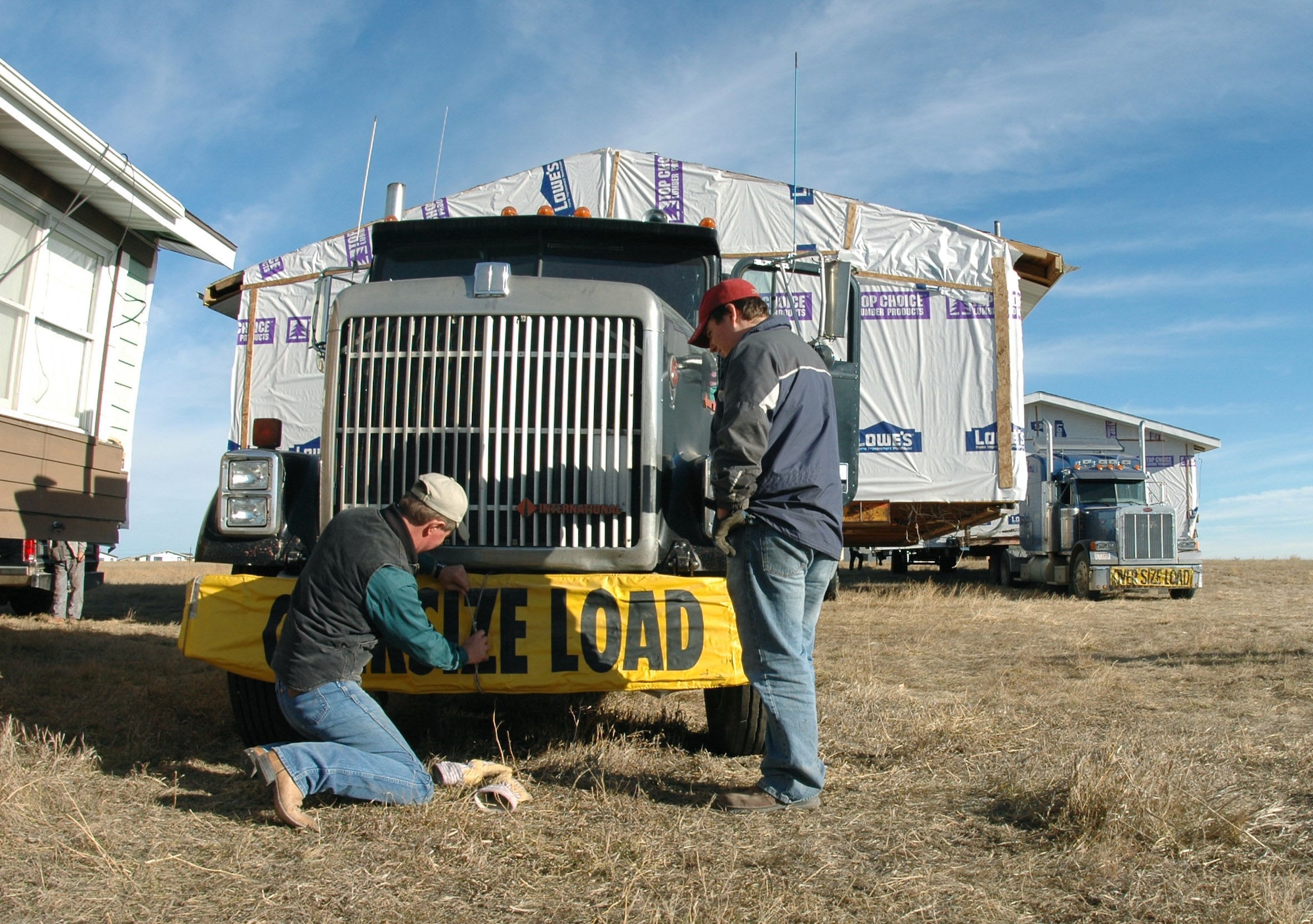 ELLSWORTH AIR FORCE BASE, S.D. -- Workers prepare to move housing units Nov. 22 from here to the Rosebud Indian Reservation.  They will become new houses for four American Indian families who have been living in condemned quarters.  (U.S. Air Force photo by Senior Airman Jason Piatek)

