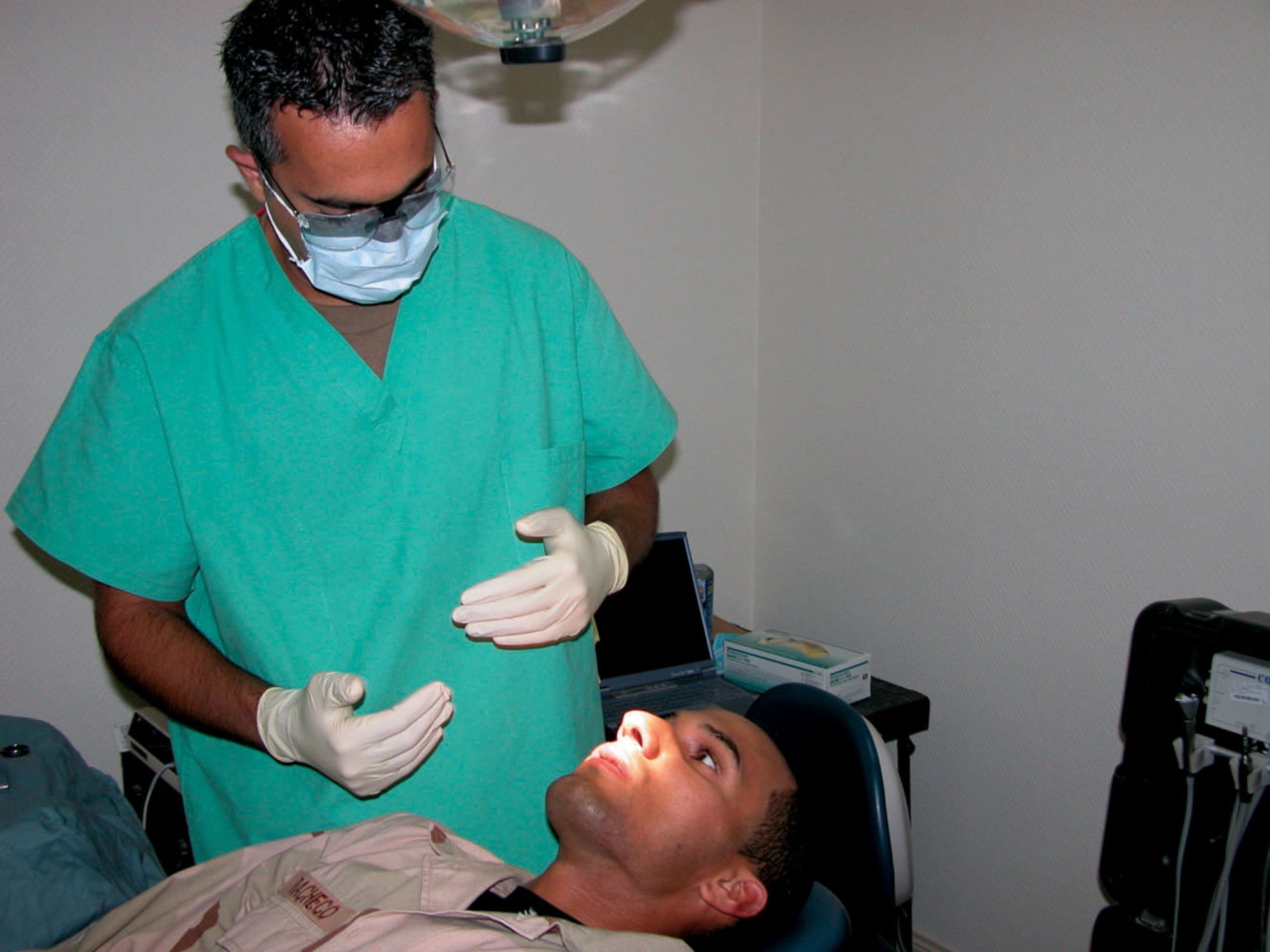 SOUTHWEST ASIA -- Capt. (Dr.) Ali Miremami meets with a patient to discuss a dental procedure.  Dr. Miremami is the only dentist assigned to the 379th Expeditionary Medical Group at a forward-deployed location.  He is responsible for the care of more than 10,000 people in the region.  (U.S. Air Force photo by Staff Sgt. Bryan Bouchard)
