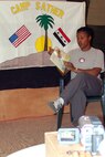 BAGHDAD, Iraq -- Staff Sgt. Tanya Evans reads "Chitty Chitty Bang Bang: The Magical Car" to her 3-year-old daughter, Tierra.  Sergeant Evans read the book on camera as part of a program created by 447th Air Expeditionary Group services flight Airmen at Camp Sather here.  She is assigned to the 447th Expeditionary Logistics Readiness Squadron and is deployed from the 56th LRS at Luke Air Force Base, Ariz.  (U.S. Air Force photo by Tech. Sgt. Michael O'Connor)