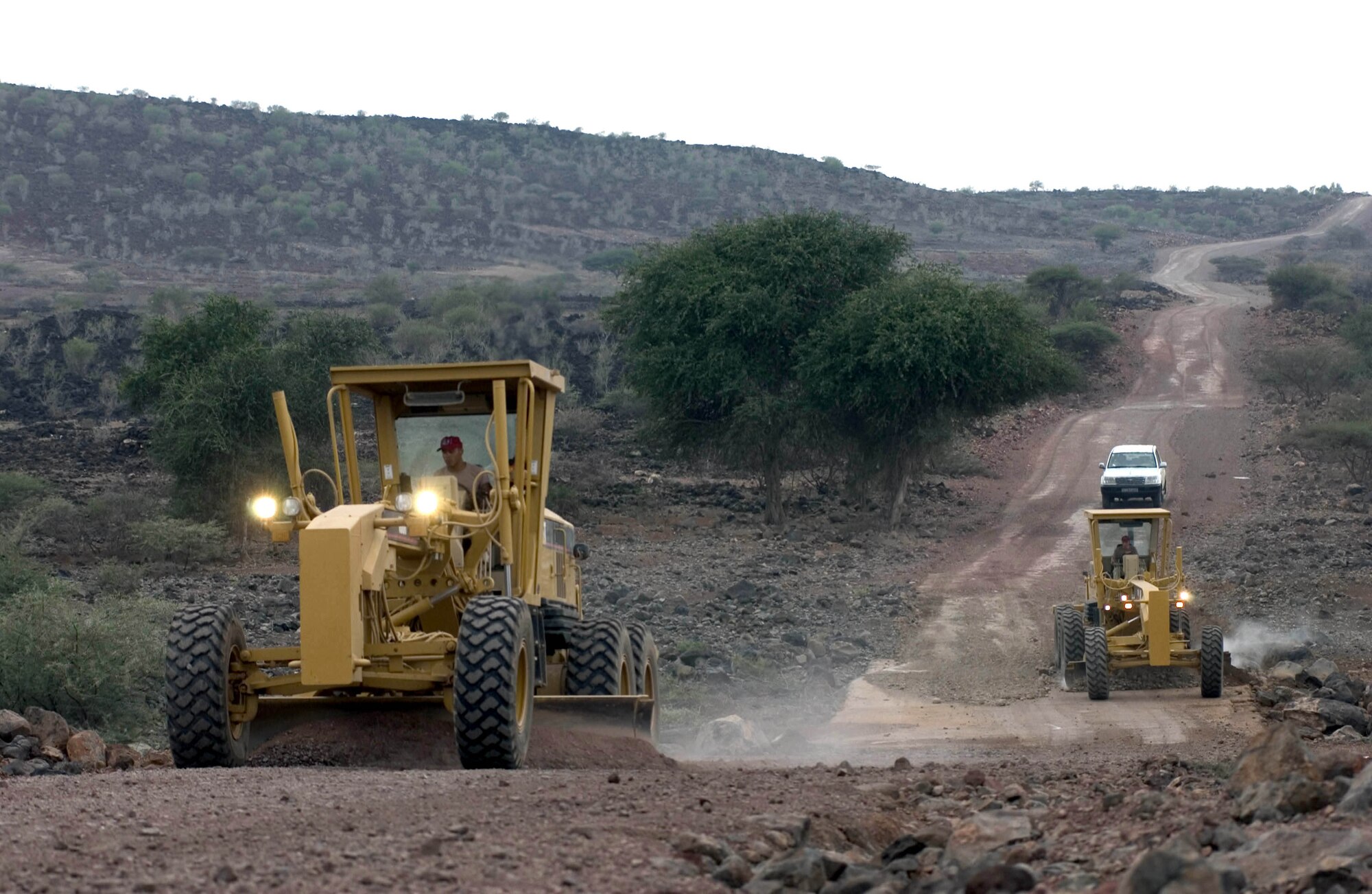 NEAR DJIBOUTI, Djibouti -- Heavy equipment operators from the 823rd Expeditionary Red Horse Squadron level 10 miles of the Hol Hol road, which connects the town of Hol Hol with Djibouti City.  The squadron is based at Hurburt Field, Fla., and is assisting the Combined Joined Task Force -- Horn of Africa to establish a secure environment and enable regional stability.  (U.S. Air Force photo by Master Sgt. John E. Lasky)
