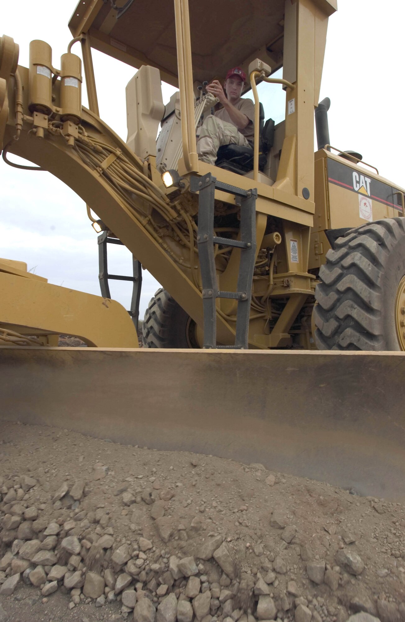 NEAR DJIBOUTI, Djibouti -- Staff Sgt. Matthew Hill drives a grader to level 10 miles of the Hol Hol road which connects the town of Hol Hol with Djibouti City.  Sergeant Hill is a heavy equipment operator with the 823rd Expeditionary Red Horse Squadron here at Camp Lemonier.  The squadron is assisting the Combined Joined Task Force -- Horn of Africa to establish a secure environment and enable regional stability.  He is from Hurburt Field, Fla.  (U.S. Air Force photo by Master Sgt. John E. Lasky)
