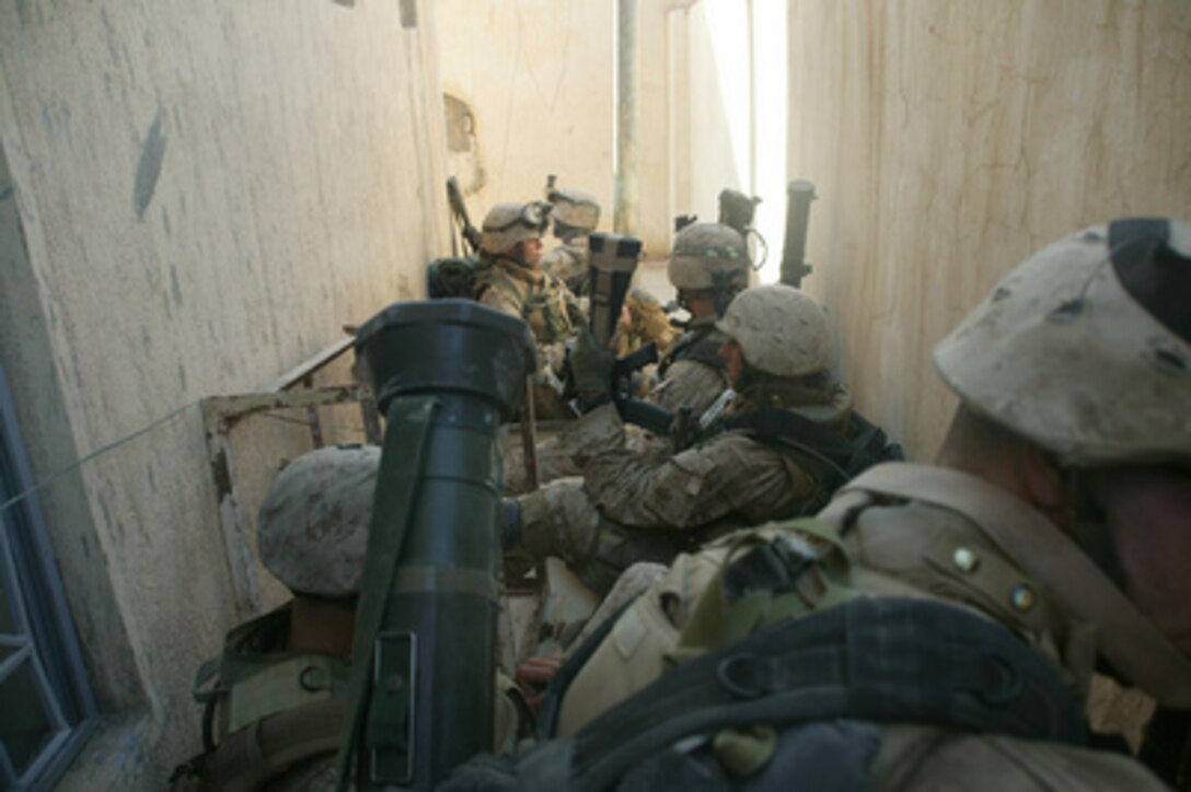 U.S. Marines take a break while searching the city of Al Fallujah, Iraq, for insurgents and weapons during Operation al Fajr (New Dawn) on Nov. 9, 2004. Al Fajr is an offensive operation to eradicate enemy forces within the city of Fallujah in support of continuing security and stabilization operations in the Al Anbar province of Iraq. 