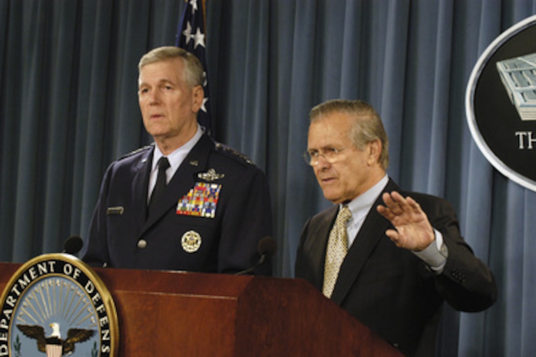 Secretary of Defense Donald H. Rumsfeld responds to a reporter's question during a joint press briefing with Chairman of the Joint Chiefs of Staff Gen. Richard B. Myers in the Pentagon on Nov. 23, 2004. 
