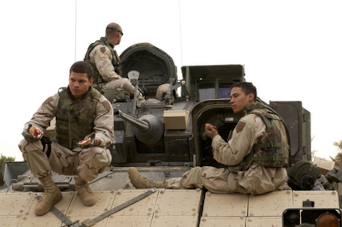 U.S. Army soldiers take a break aboard their M3A3 Bradley Cavalry Fighting Vehicle during a combat security patrol outside Ancient Samarra, near Ad Dwr, Iraq, on Nov. 17, 2004. The soldiers are assigned to 1st Battalion, 4th Cavalry Regiment, 1st Infantry Division. 