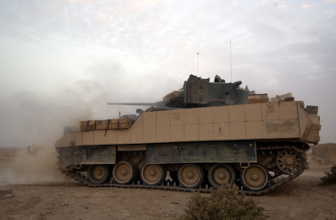 A U.S. Army M3A3 Bradley Cavalry Fighting Vehicle test fires its 25-millimeter chain gun while on a combat security patrol outside Ad Dwr, Iraq, on Nov. 17, 2004. The Bradley and its crew are assigned to Charlie Troop, 1st Battalion, 4th Cavalry Regiment, 1st Infantry Division. 